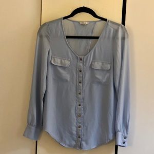 Light blue blouse with gold buttons